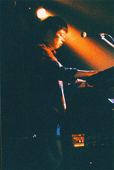 Noguchi plays the keyboards and sings the harmony.