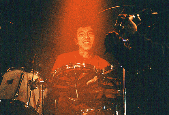 Tamura smiles so much while playing the drums.